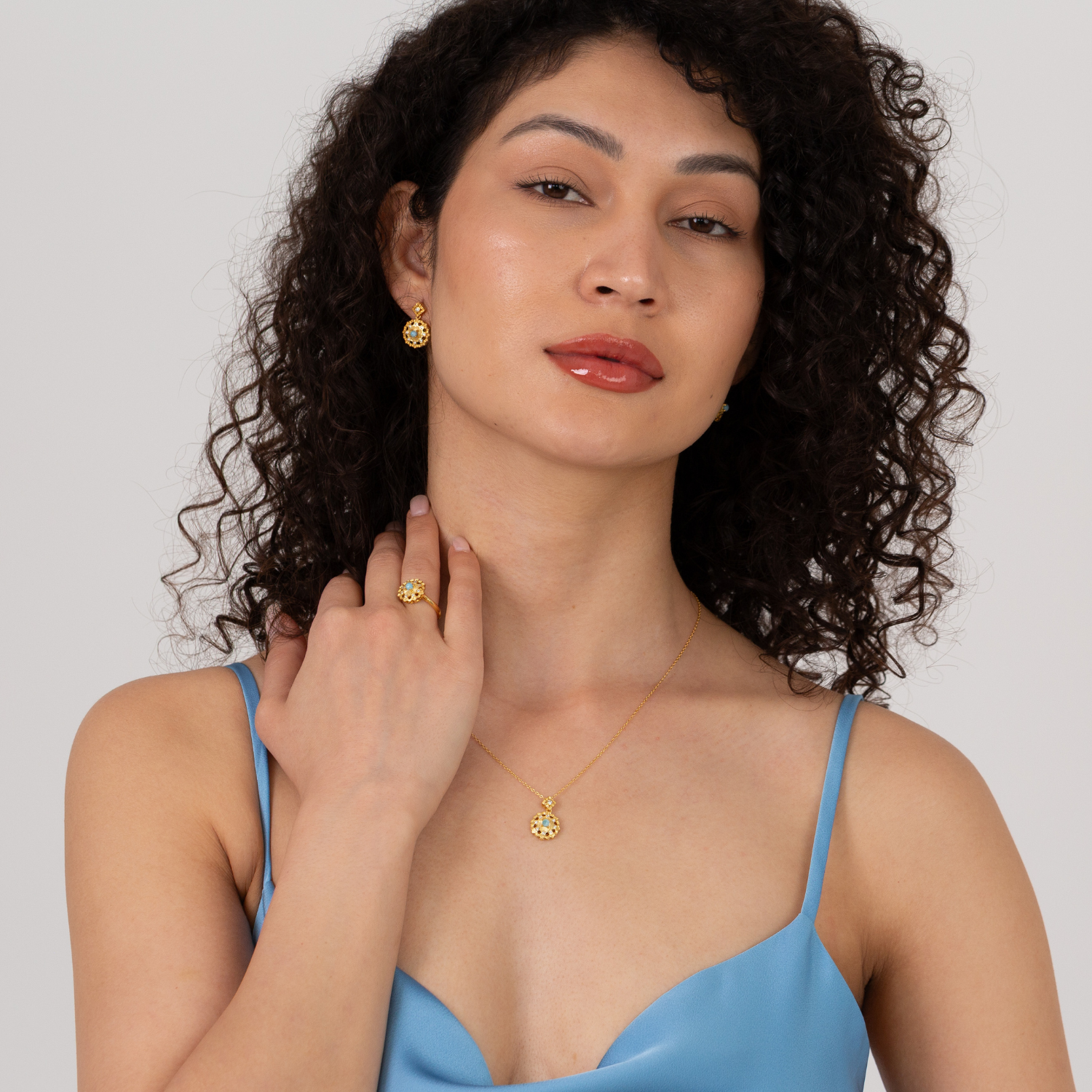 model wearing 18k gold plated sterling silver blue larimar jewellery set