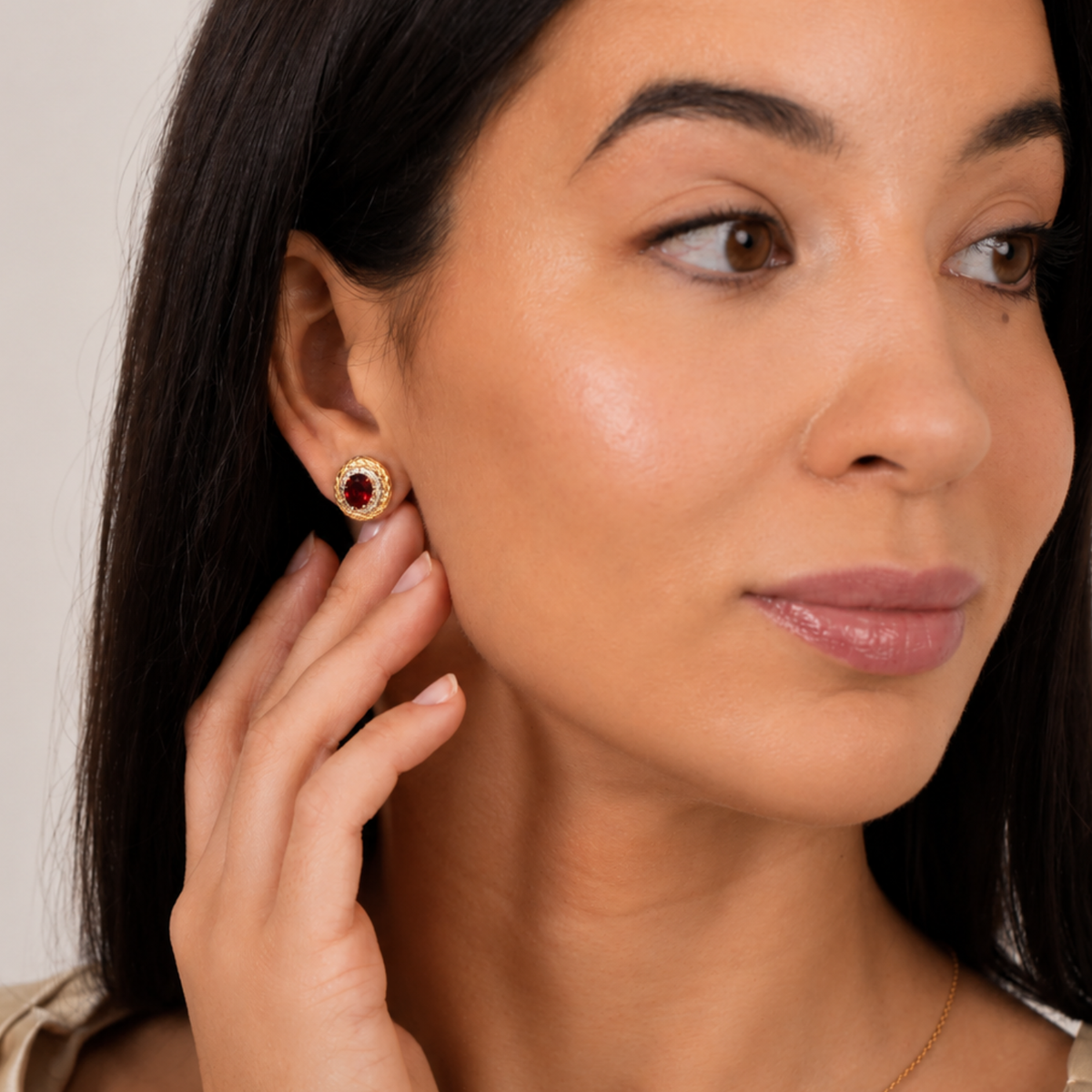 model wearing 18k gold plated sterling silver garnet halo earrings