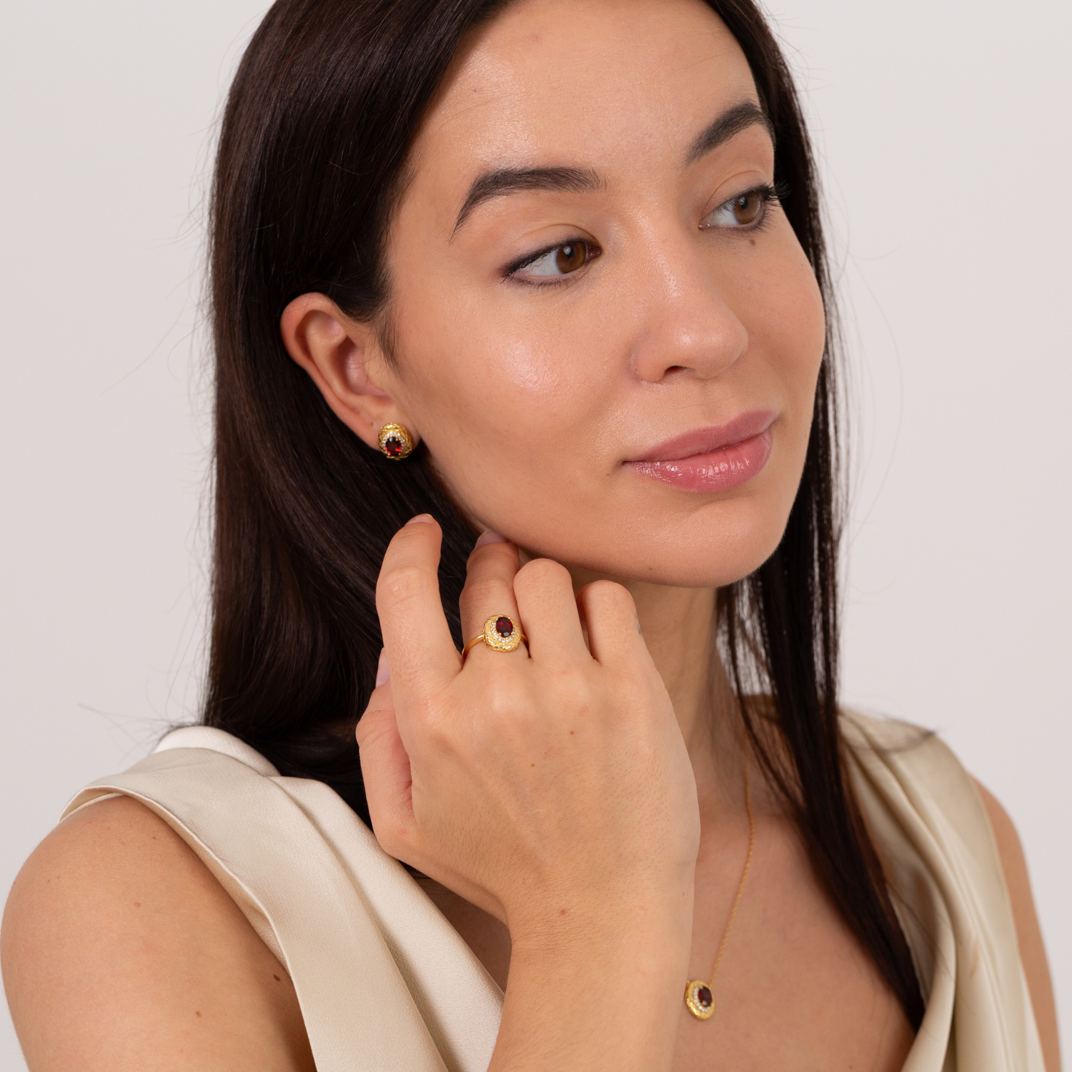 model wearing 18k gold plated sterling silver garnet halo jewellery set