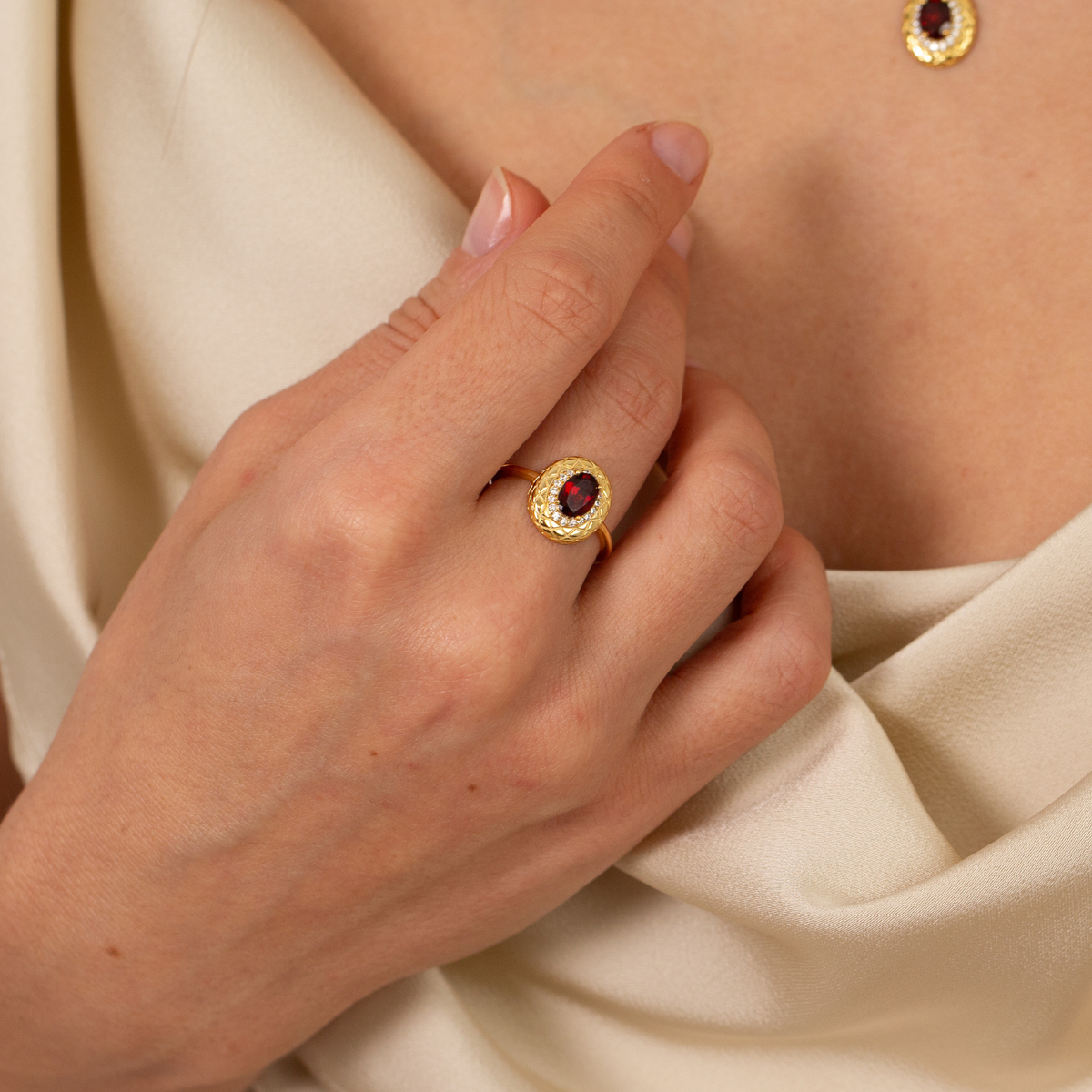 model wearing 18k gold plated sterling silver garnet halo ring necklace