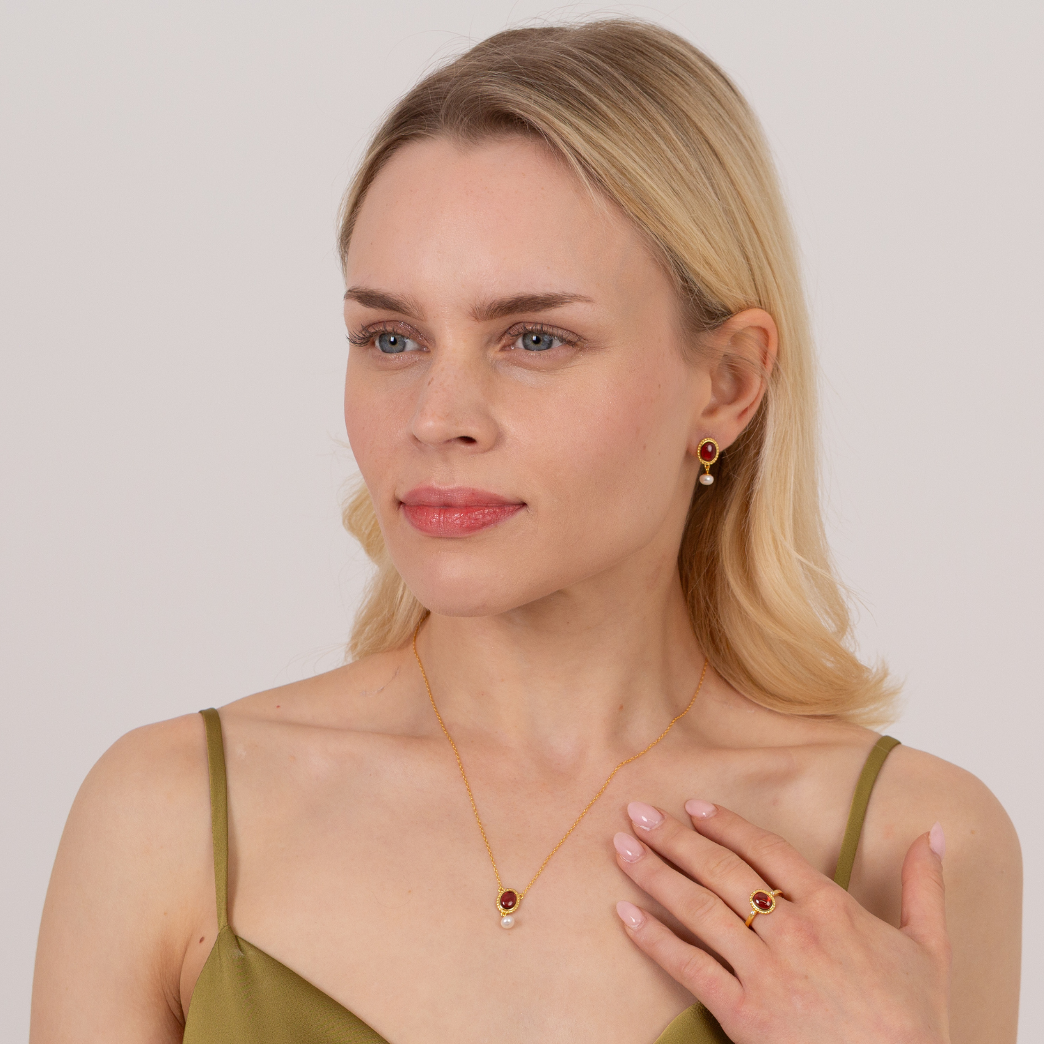 model wearing 18k gold plated sterling silver garnet pearl drop jewellery set