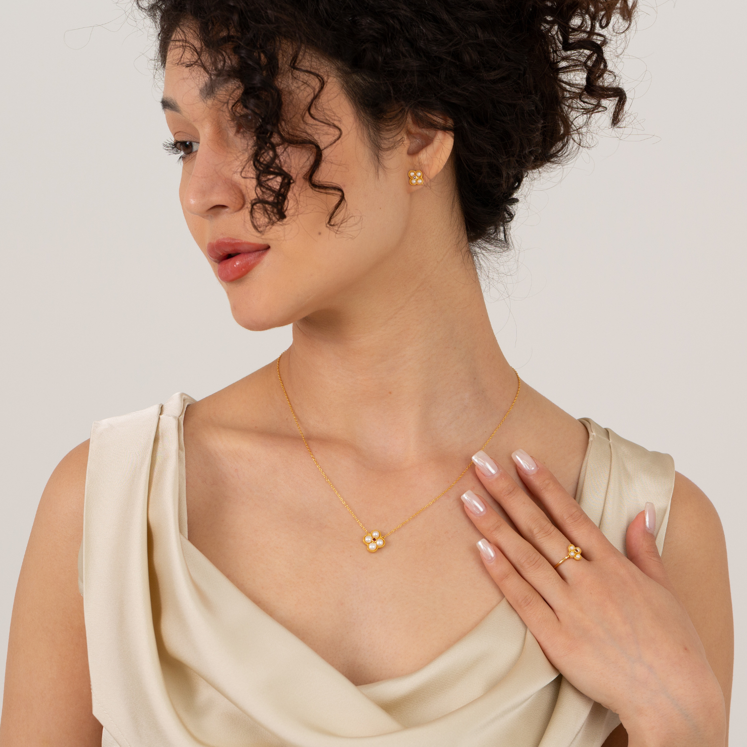 model wearing 18k gold plated sterling silver pearl garnet floral jewellery set