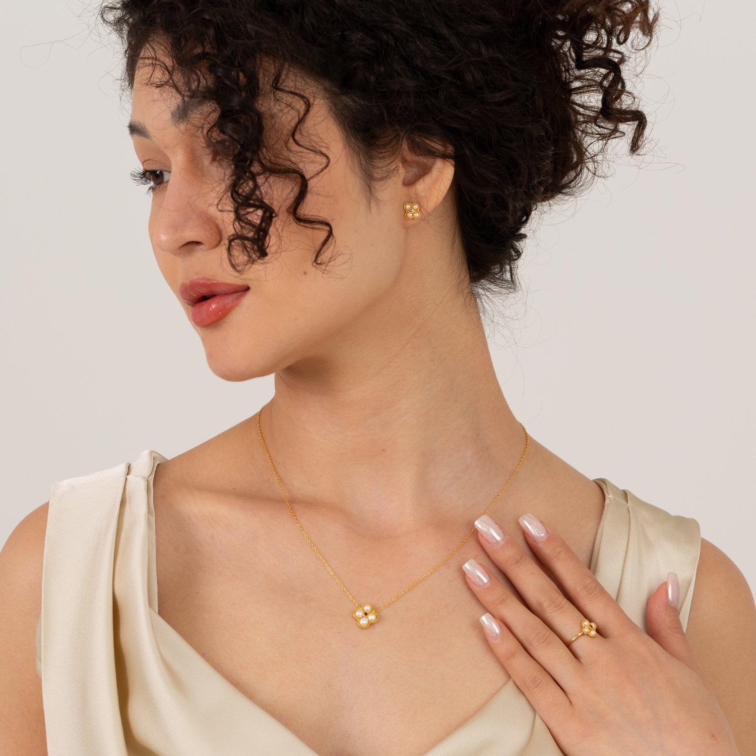 model wearing 18k gold plated sterling silver pearl garnet floral jewellery set