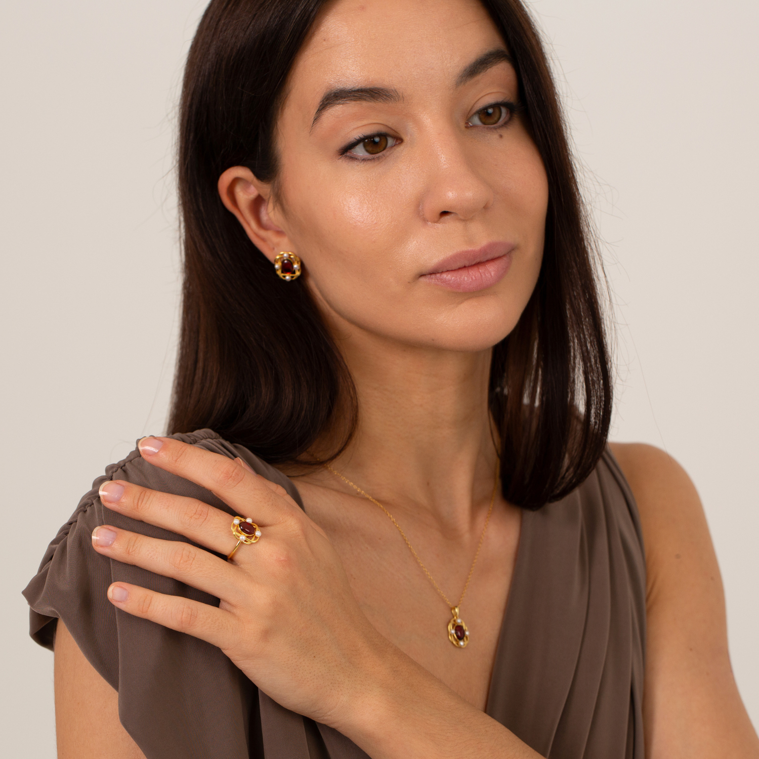 model wearing 18k gold plated sterling silver pearl garnet jewellery set