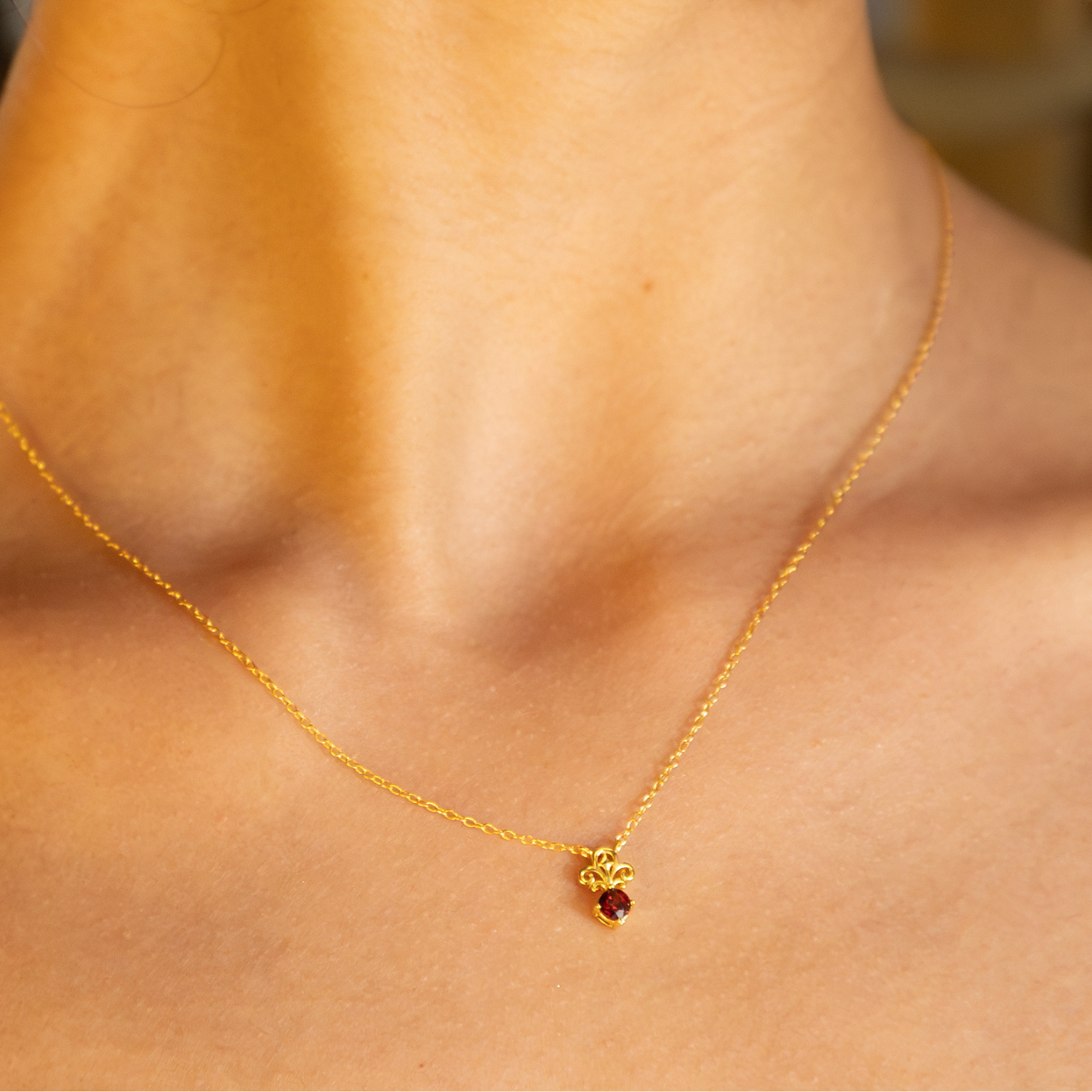 model wearing 18k gold plated sterling silver garnet tijou necklace