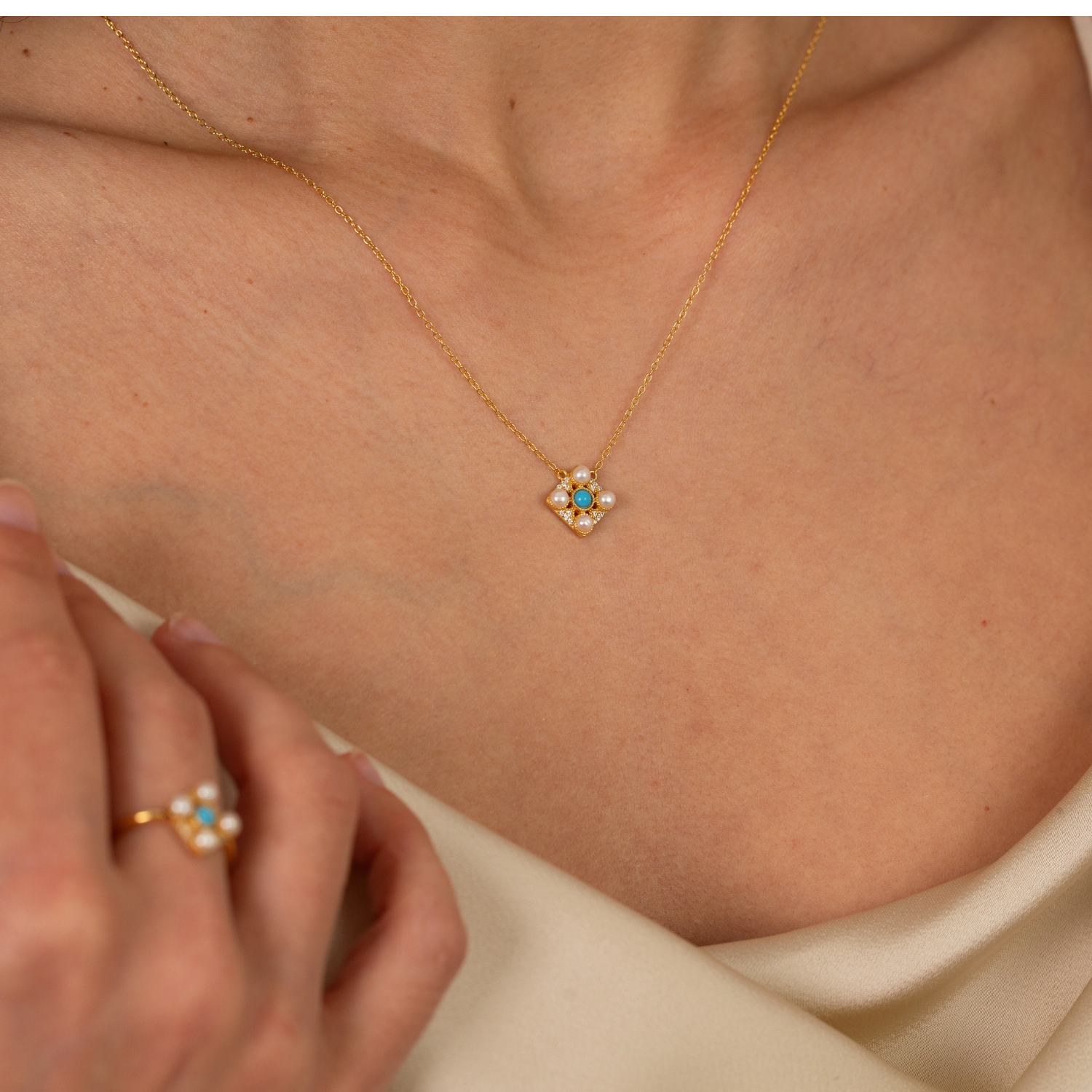 model wearing 18k gold plated sterling silver turquoise pearl necklace and ring