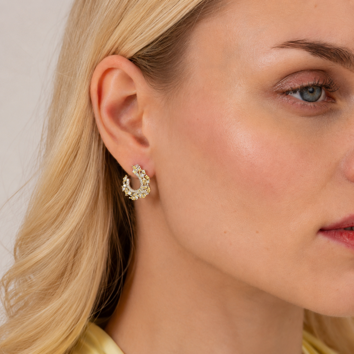 model wearing 925 sterling silver yellow cubic zirconia earrings