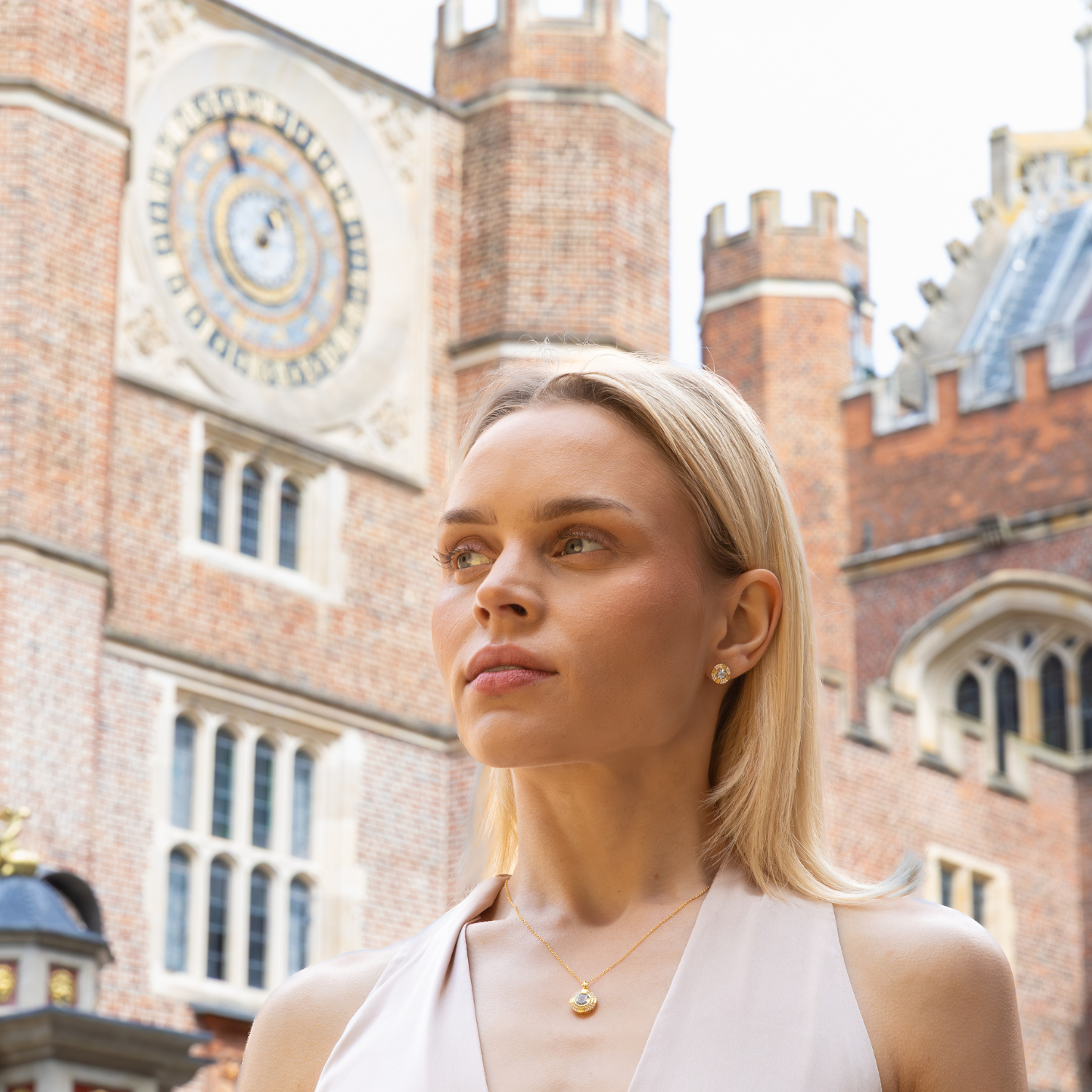 model wearing 18k gold plated sterling silver blue topaz clock necklace