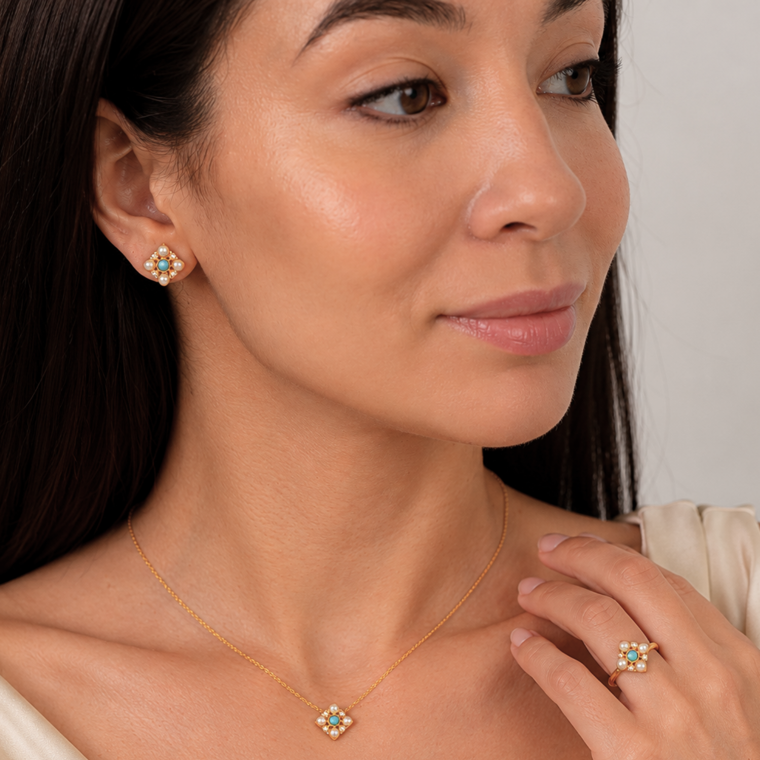 model wearing 18k gold plated sterling turquoise pearl jewellery set