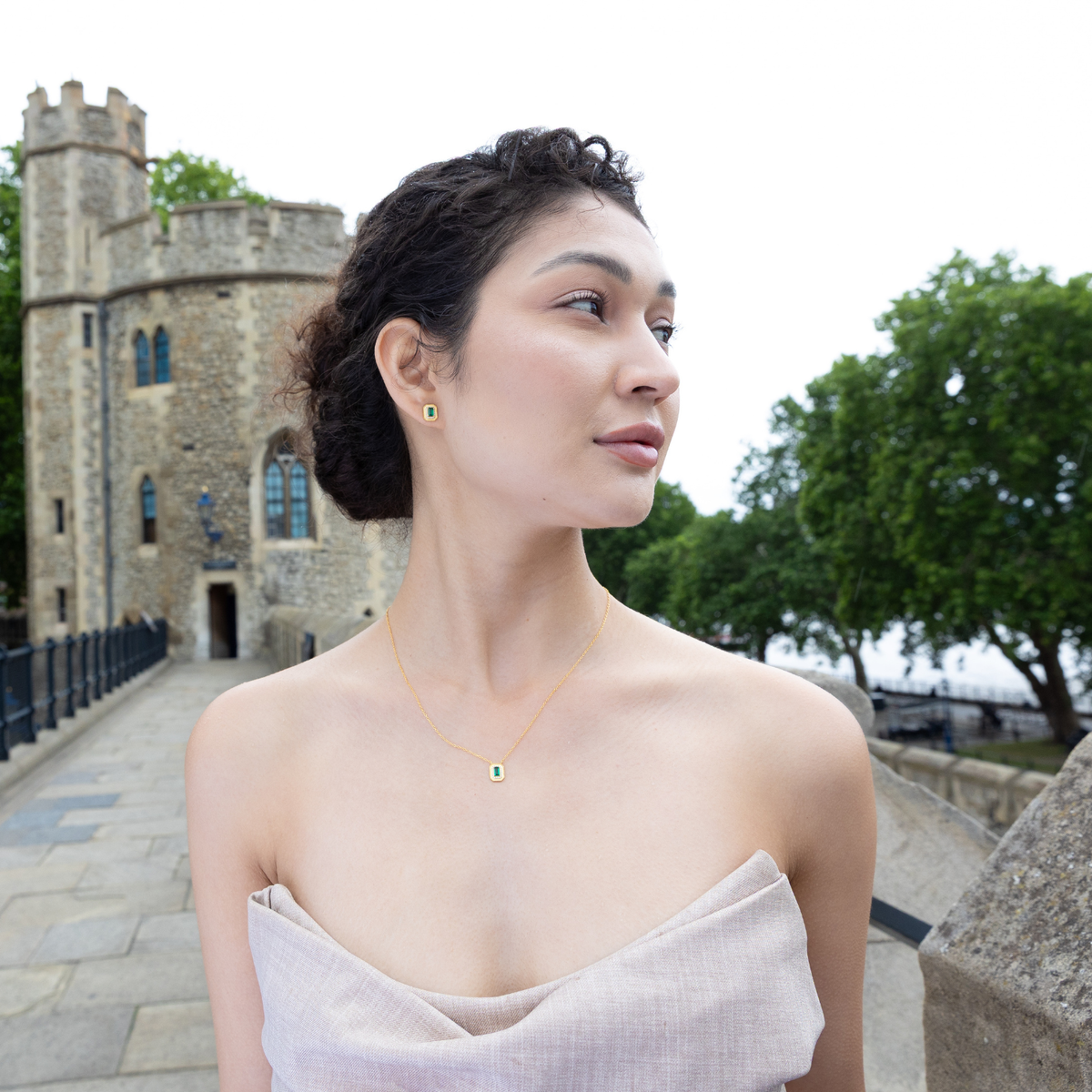 model standing outside tower of london wearing gold moissanite jewellery set