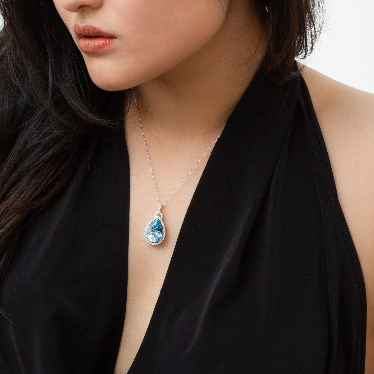 model wearing 925 sterling silver pear drop blue topaz necklace