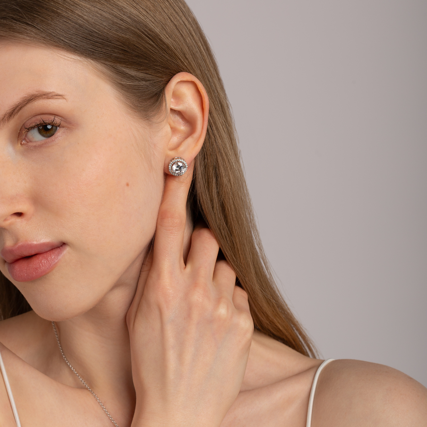 model wearing 925 sterling silver white topaz stud earrings