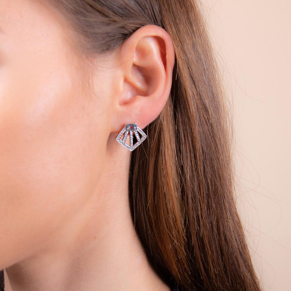 model wearing silver blue topaz sakura stud earrings