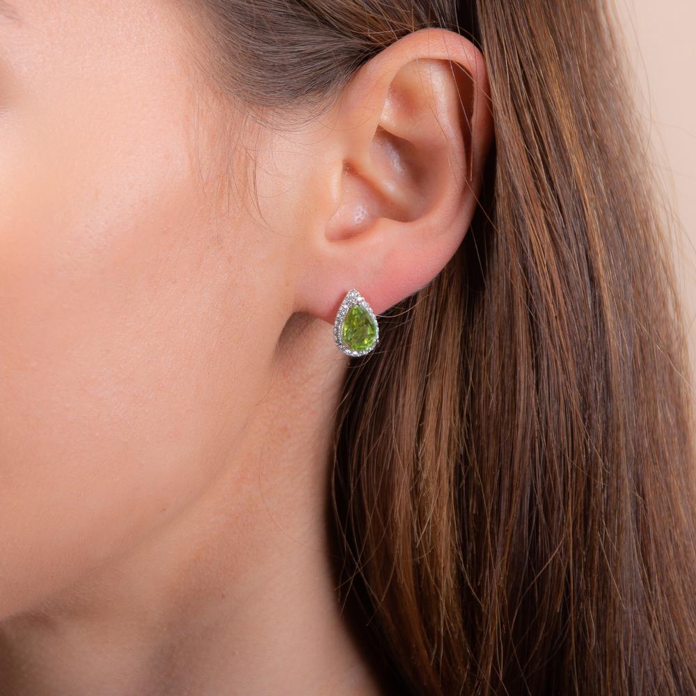 model wearing 925 sterling silver peridot pear drop stud earrings